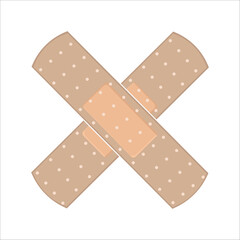 Two crossed adhesive bandages with polka dot pattern on a white background