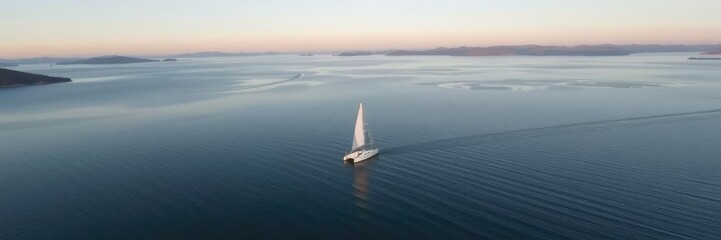 Fototapeta premium Drone view of a sailboat gliding across the surface of Lake Tahoe, lake scenery, lake tahoe california