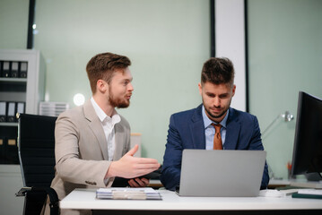 Caucasian business team collaborates on a new startup project, planning strategies with a tablet and laptop