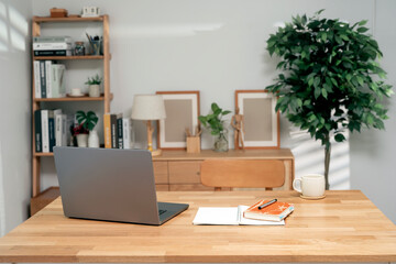 Creative home office workspace concept. Rear view of laptop comopter on wooden table, copy space,...