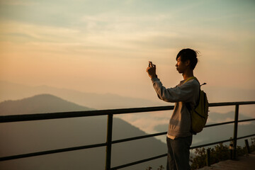 Man traveler with camera backpack hiking outdoor travel lifestyle and adventure concept. cap...