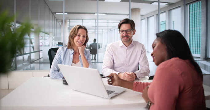 Happy Couple Discussing Financial Planning with Tax Accountant - Powered by Adobe
