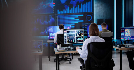 Analyzing KPI Dashboard graphs on a black tablet in office