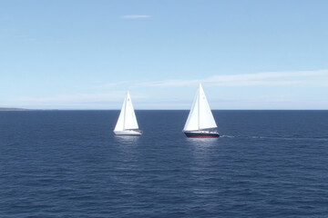 Two sailboats are sailing in the ocean
