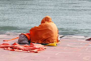A holy saint sitting on a bed of Ganga river at Rishikesh.