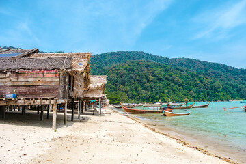 Escape to Surin Island Thailand with tranquil beaches and vibrant boats under a clear blue sky