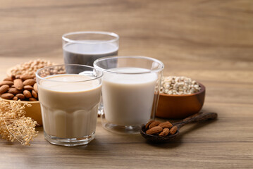 Alternative milk made from plant on wooden background, non dairy, Vegan food