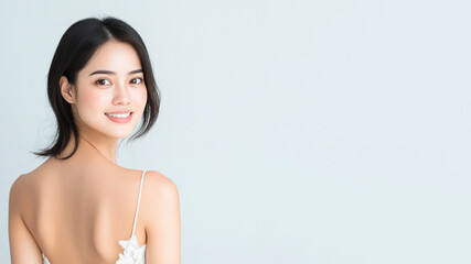 Fototapeta premium Indonesian woman wearing a white dress with a rose pattern smiling isolated