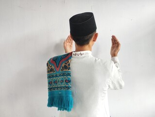 Back view of moslem man doing praying gesture