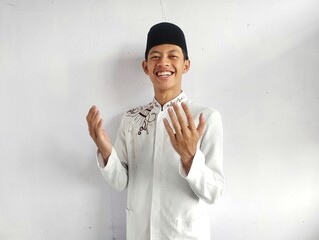 Moslem Asian man smiling and showing grateful gesture
