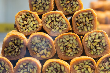 Detailed view of Turkish pistachio rolls, showcasing the nut-packed filling and golden pastry shell, a classic Middle Eastern dessert.