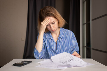 Stressed woman with debt utility bill, frustrated with high gas invoice, struggling with finance