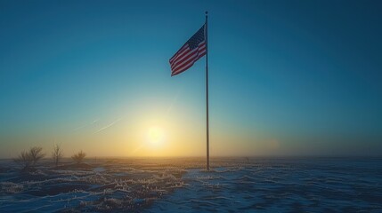 Fototapeta premium American Flag at Sunrise Over a Vast, Icy Landscape