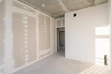 rough repairs for self-finishing. interior decoration, bare walls of the room, stage of construction. interior apartment room