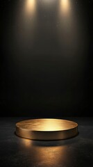 golden circular podium on the left side of an empty dark background, with light shining from above. 