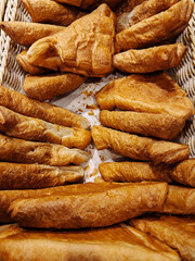 Delicious assortment of freshly baked pastries displayed in a basket at a local bakery during the morning