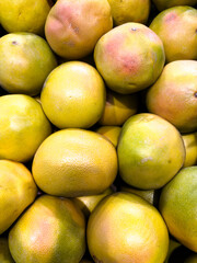 Fresh citrus fruits stacked beautifully at a local market ready for customers to buy and enjoy healthy snacks
