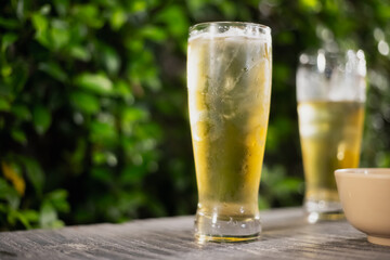 Beer glass on wooden board . Blurred background party party. Cold beer.
