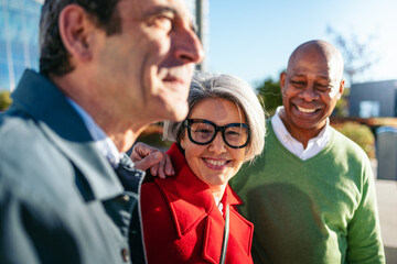 Senior friends sharing warm smile during outdoor meetup