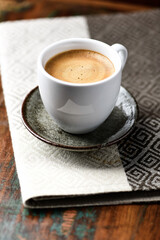 Cup of coffee on wooden background. Soft focus.