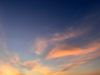 Clouds and orange sky,Real majestic sunrise sunset sky background with gentle colorful clouds without birds.Panorama, large
