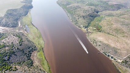 aerial view of river and speedboat