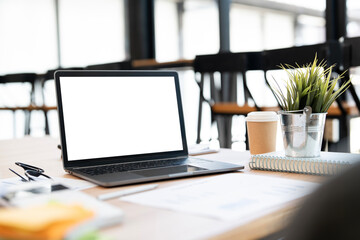 Mockup blank screen laptop computer on wooden table, creative workspace..