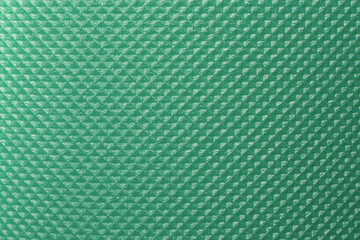 Ribbed green surface of a camping mat as texture, background