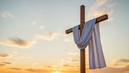 Wooden cross with flowing white cloth against a sunrise sky, symbolizing hope and resurrection during Easter