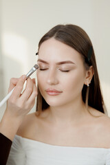 Female caucasian young adult eyebrow tinting and correction in progress