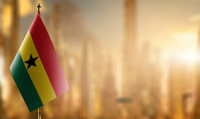 Small flags of the Ghana on an abstract blurry background
