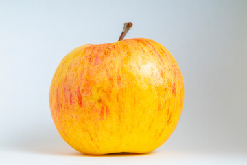 Ripe organic yellow apple on a white background