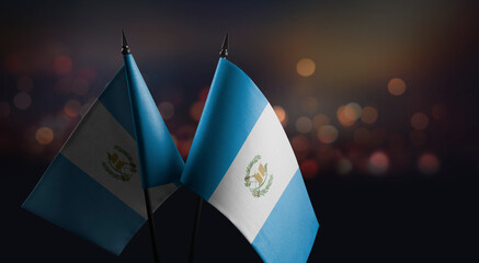 Small flags of the Guatemala on an abstract blurry background