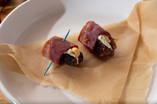 A view of an appetizer plate of devils on horseback.