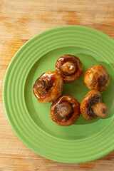 A top down view of a plate of teriyaki mushrooms.