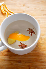 A top down view of a flu remedy drink in a white ceramic mug.