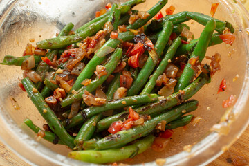 A view of a bowl of sauteed green beans.