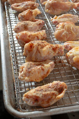 A view of the process of seasoning dry rub chicken wings.