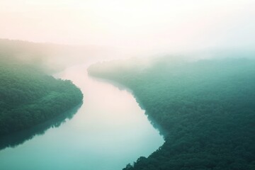 Misty morning river flows through lush green forest, creating a serene and tranquil landscape.