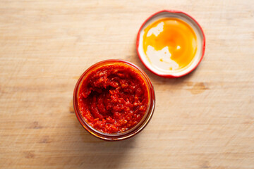 A top down view of a jar of harissa.