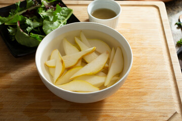 A view of the process of preserving sliced pears.
