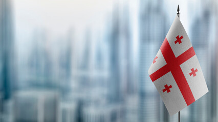 Small flags of the Georgia on an abstract blurry background