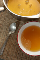 A top down view of a bowl of bone broth.