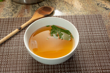 A view of a bowl filled with bone stock.