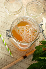 A view of a large glass jar filled with bone broth.