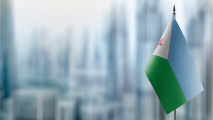 Small flags of the Djibouti on an abstract blurry background