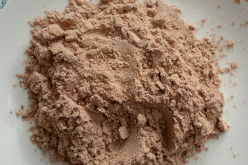 A top down view of a pile of chocolate protein powder.