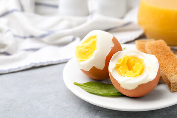 Soft boiled eggs with bread on grey table, closeup. Space for text