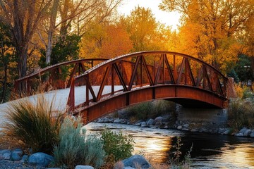 A serene wooden bridge spans across a gentle river flowing through a lush green park
