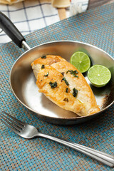 A view of a small frying pan of tequila lime chicken breast.
